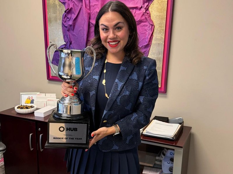 Jessica holding her Rookie of the Year trophy